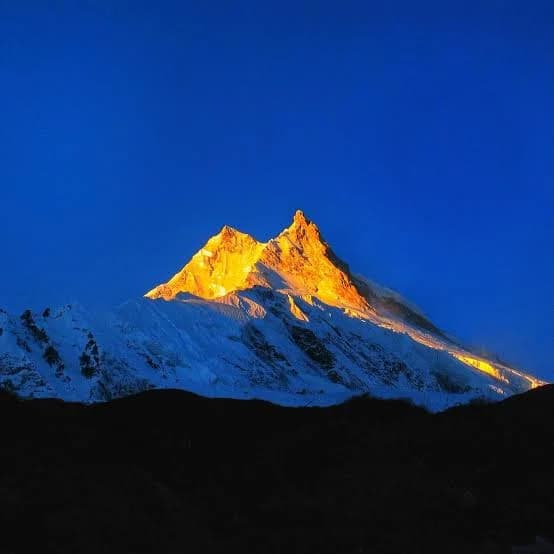Golden mountain peak at sunrise